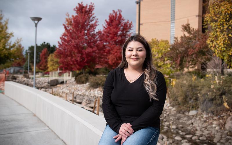 First-generation Aims student Daisy Pina seated outdoors on the Greeley campus