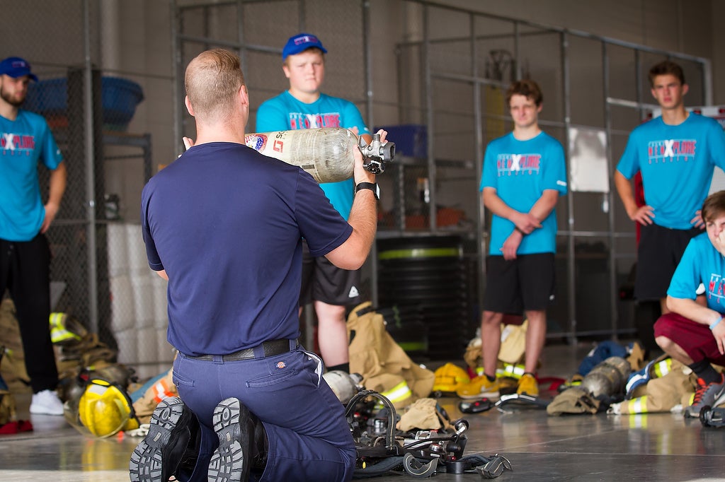 Aims fire science Xplore Academy students learning about fire safety equipment