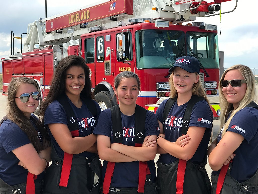 A group photo of Aims fire science Xplore Academy students in front of a fire truck