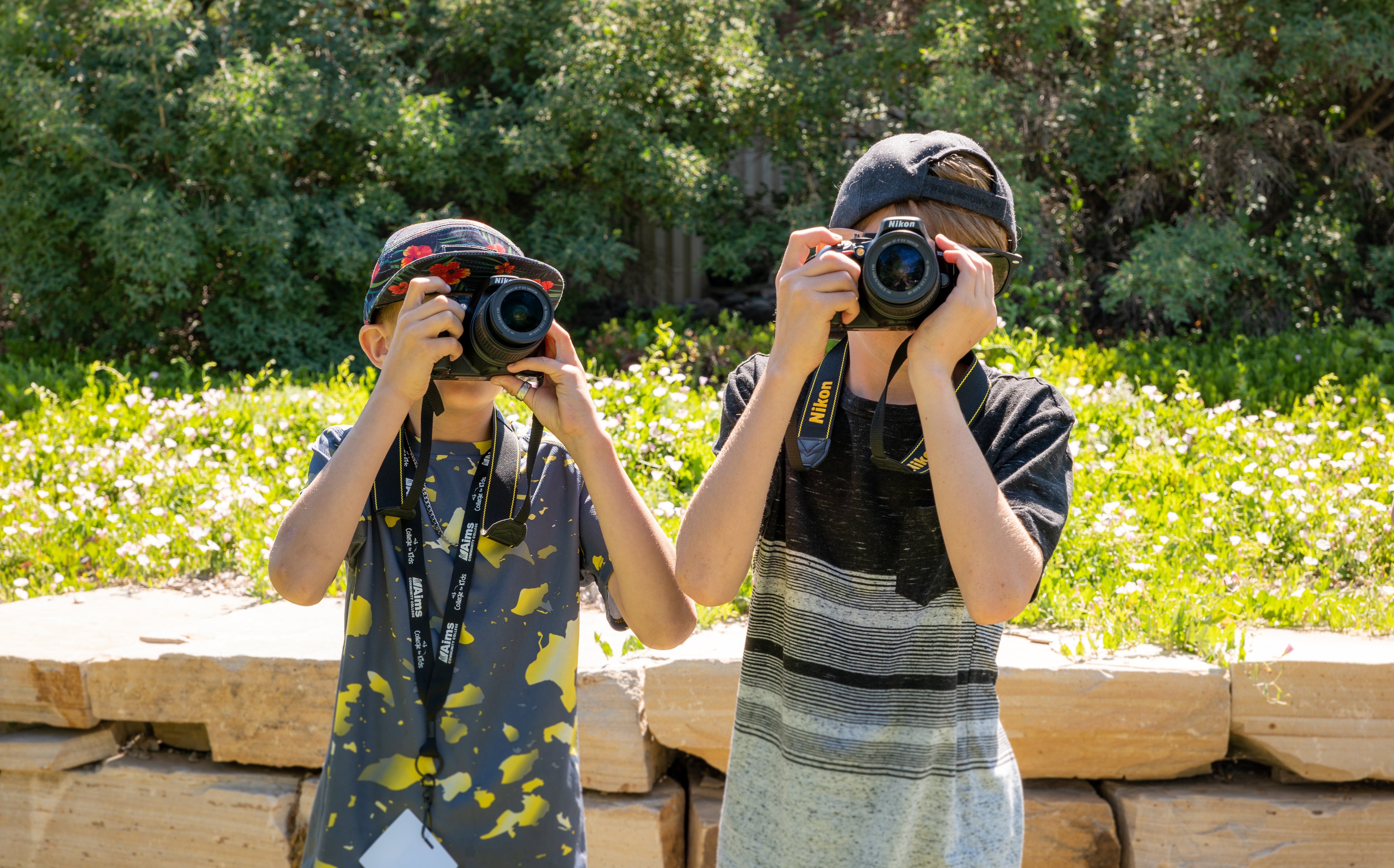 College for kids, two kids taking photos outside