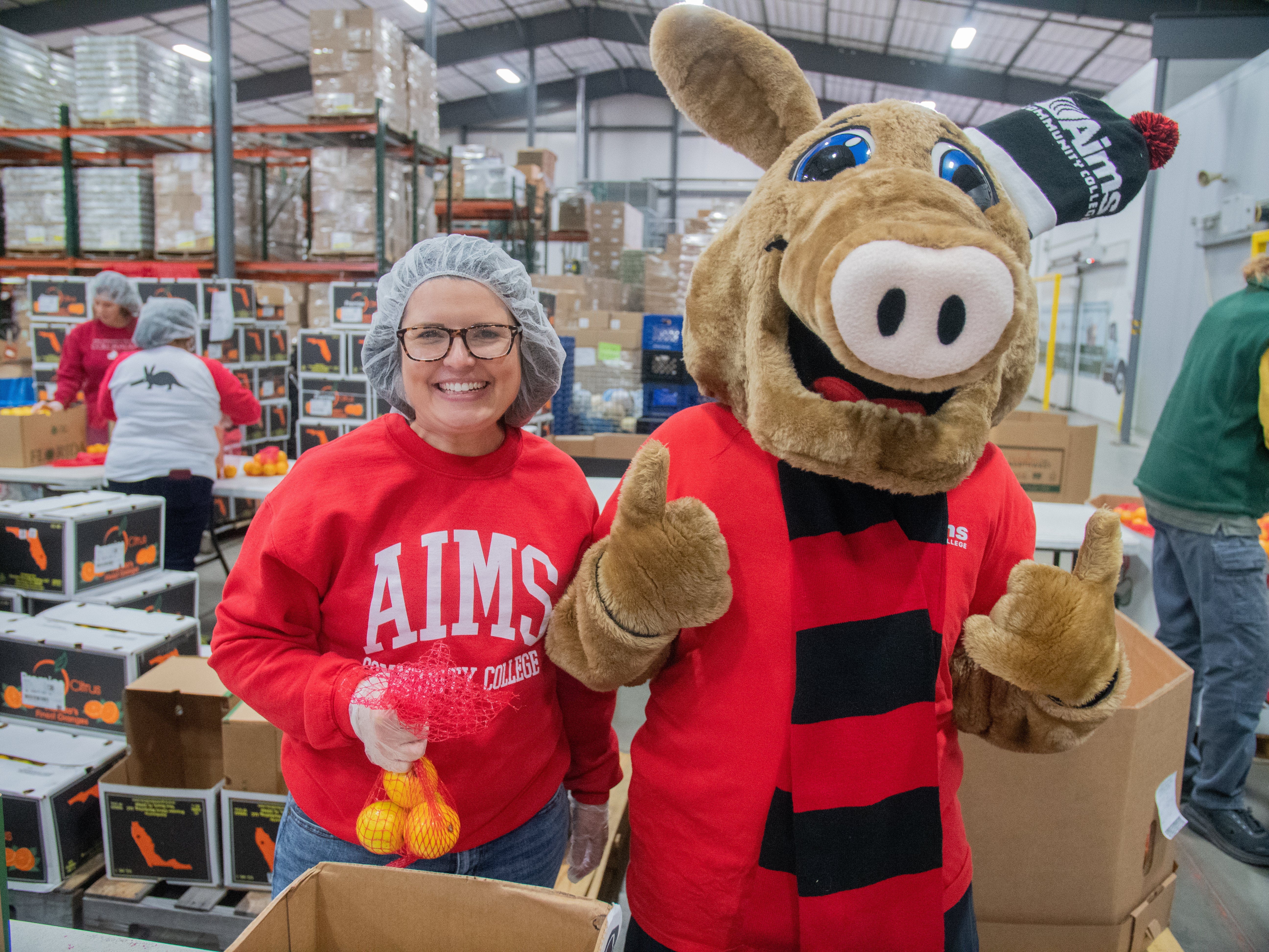 Aims Community College staff member and Arty the Aardvark posing during a Weld County Food Bank charity event