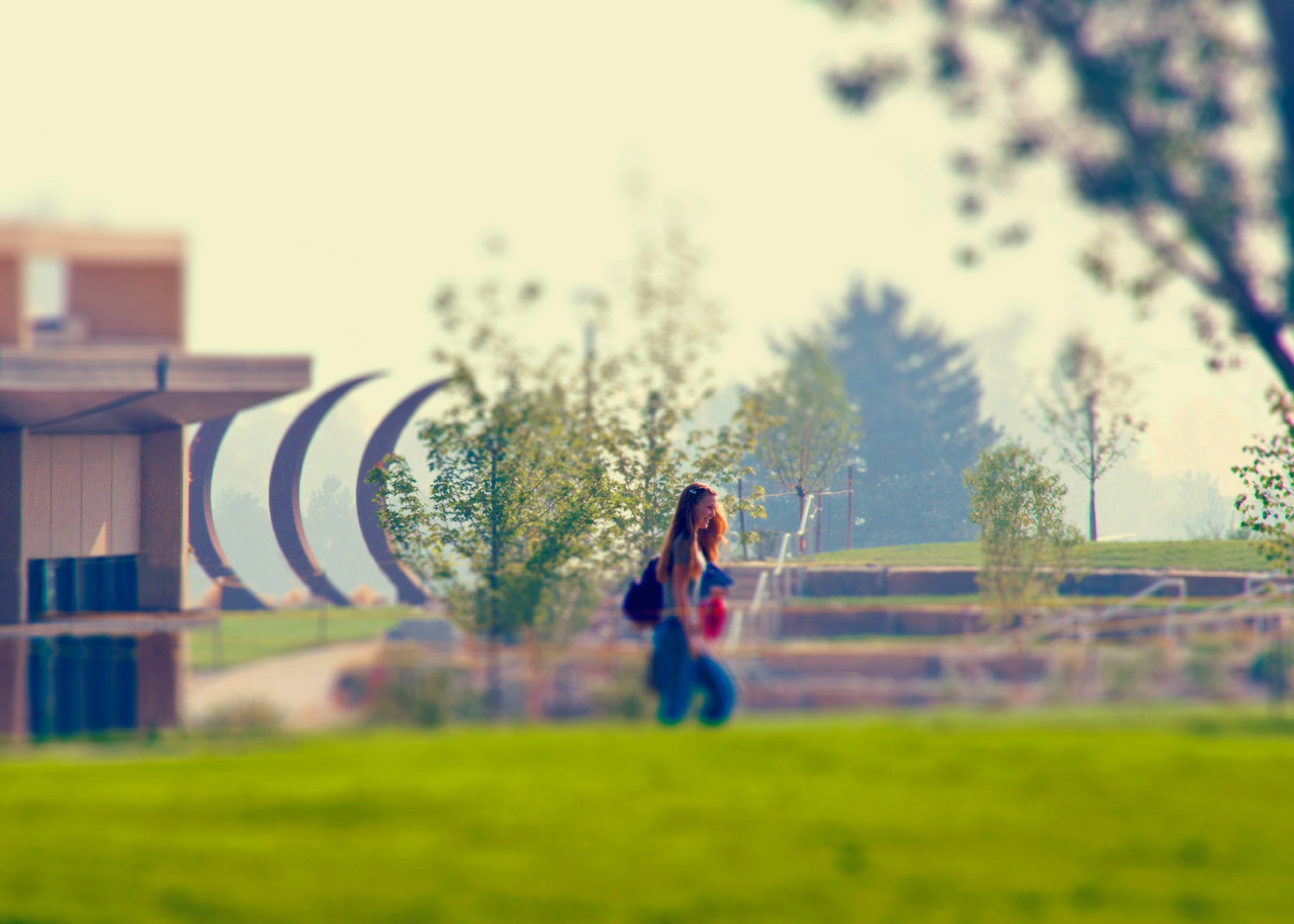 A student walking along the Aims Community College promenade