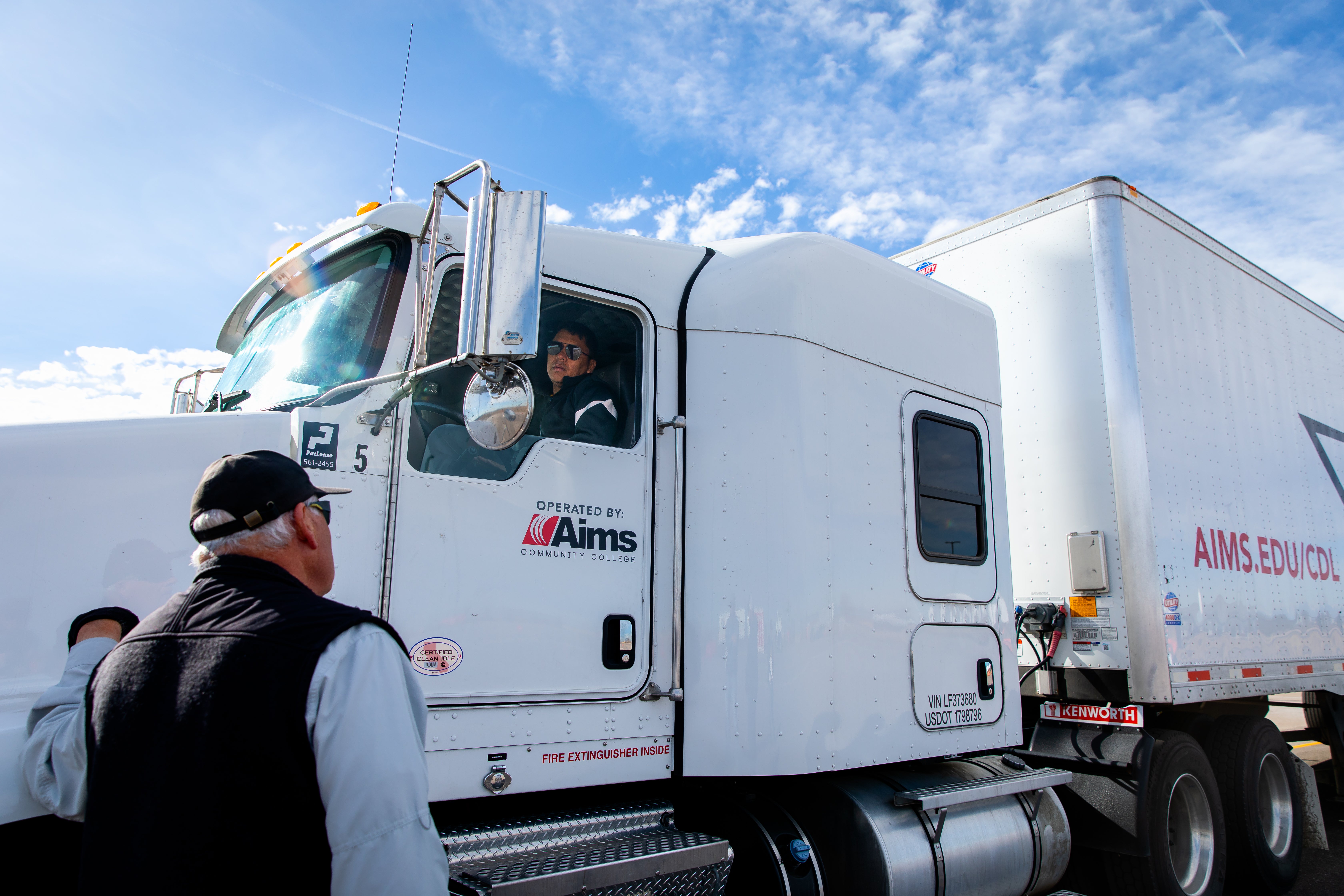 CDL trainer talks to student in truck