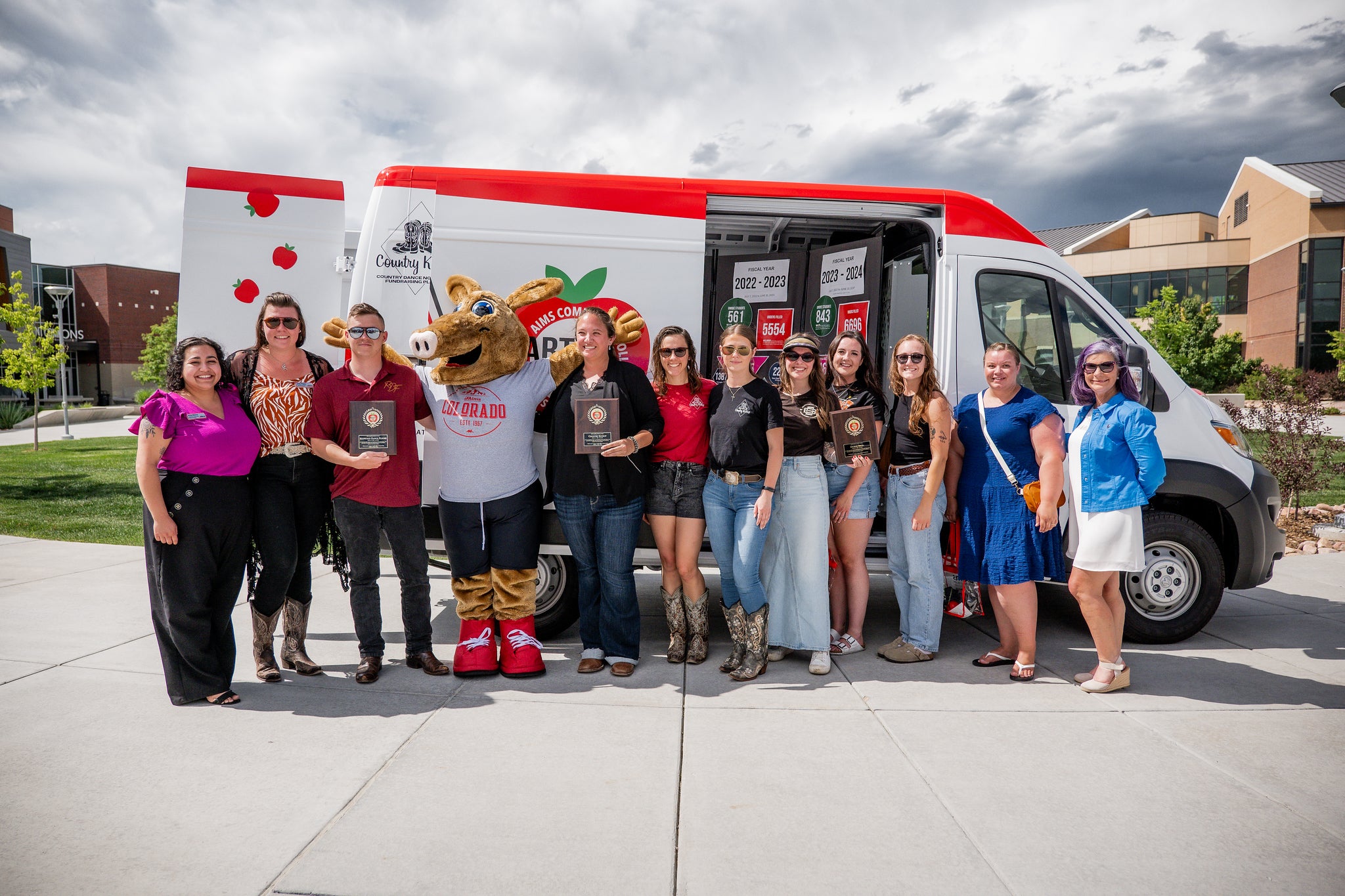 Aims staff celebrating the reveal of the Arty's Pantry van