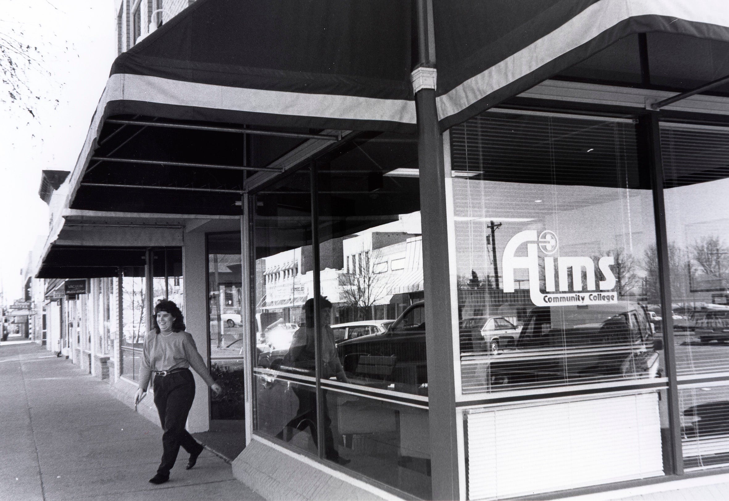 A person standing in front of the Loveland Campus building in downtown Loveland, Colorado in 1995.