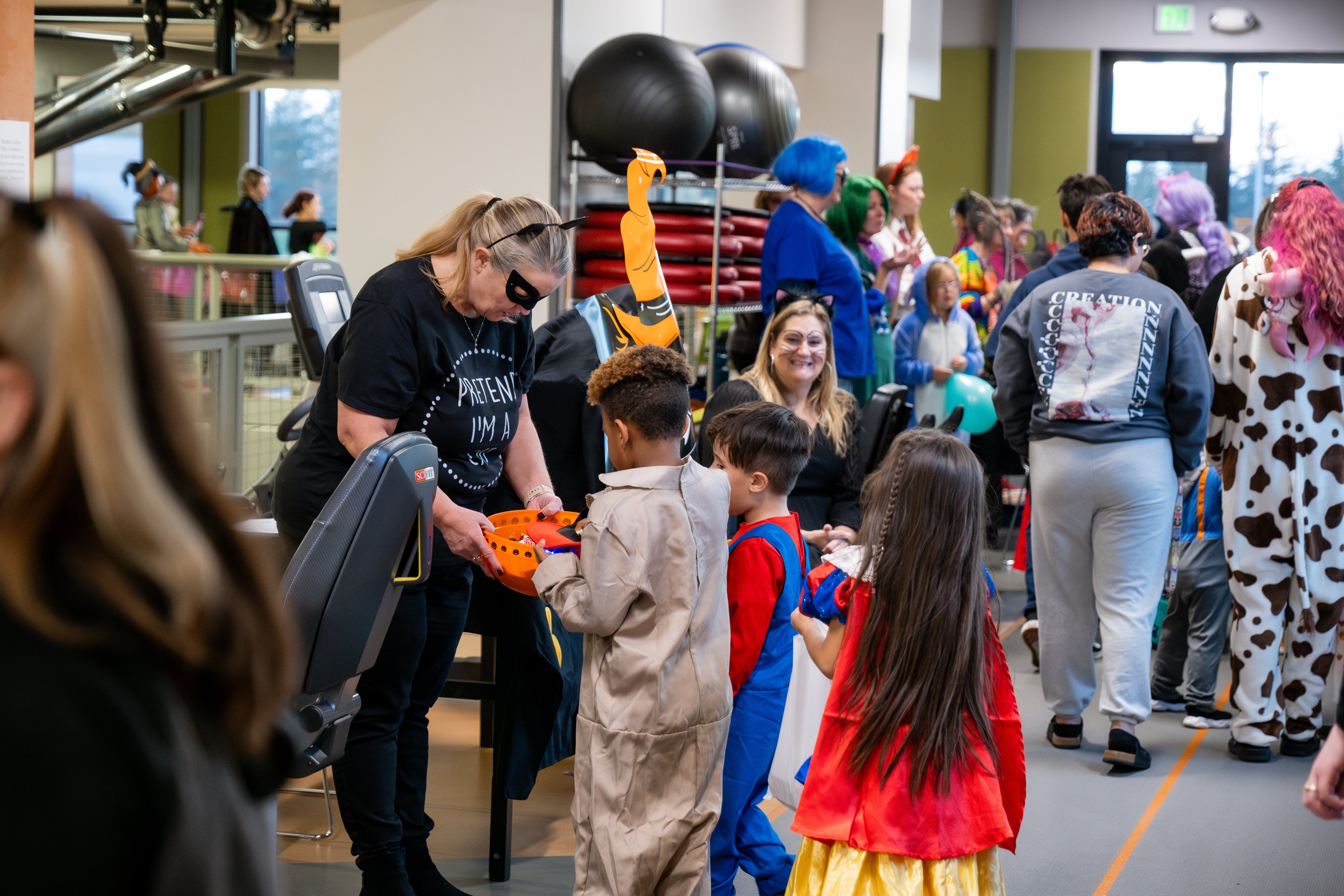 Children trick or treat inside the PERC.