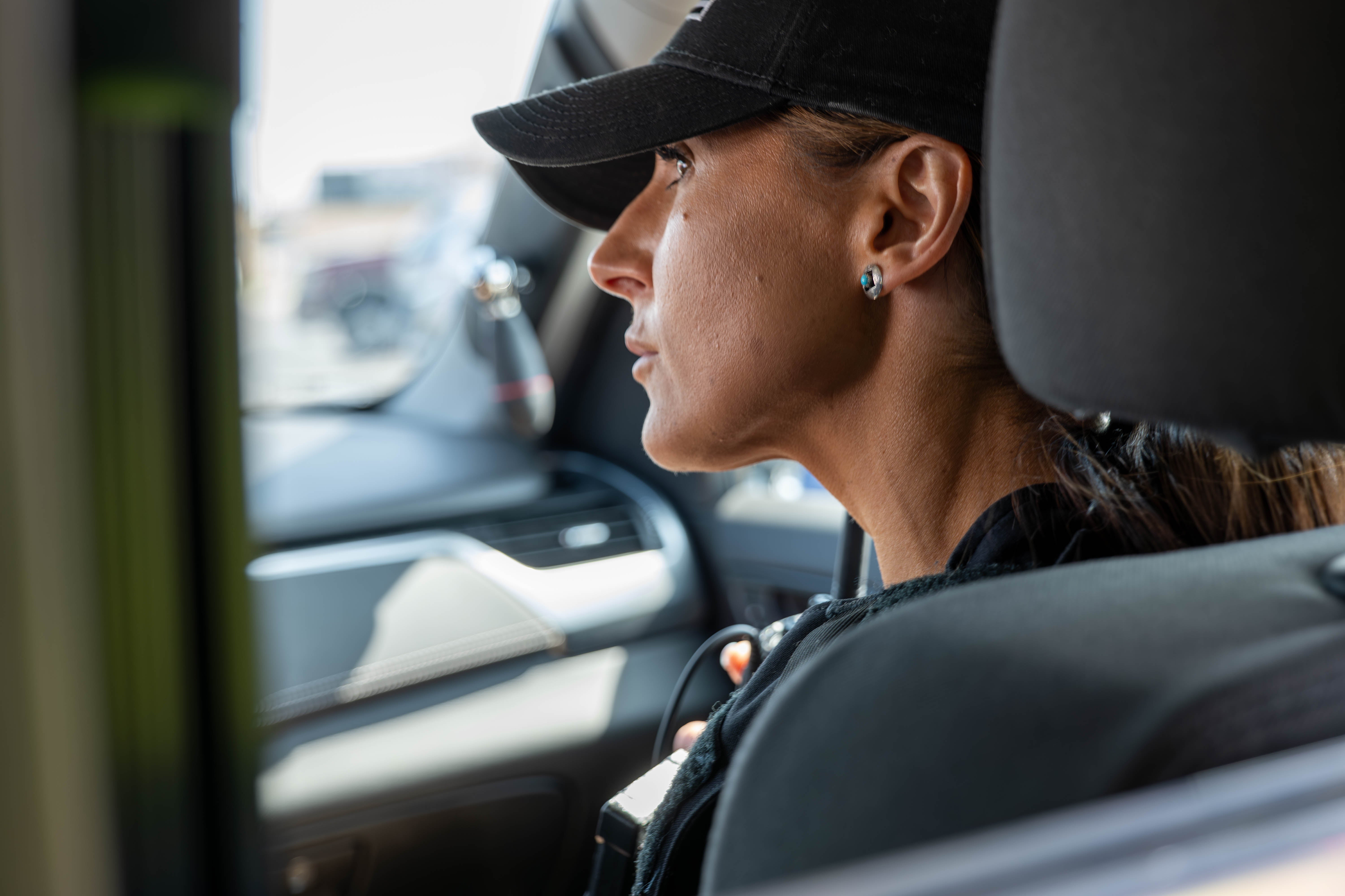 An Aims Peace Officer Academy cadet listening intently during a training exercise inside a vehicle