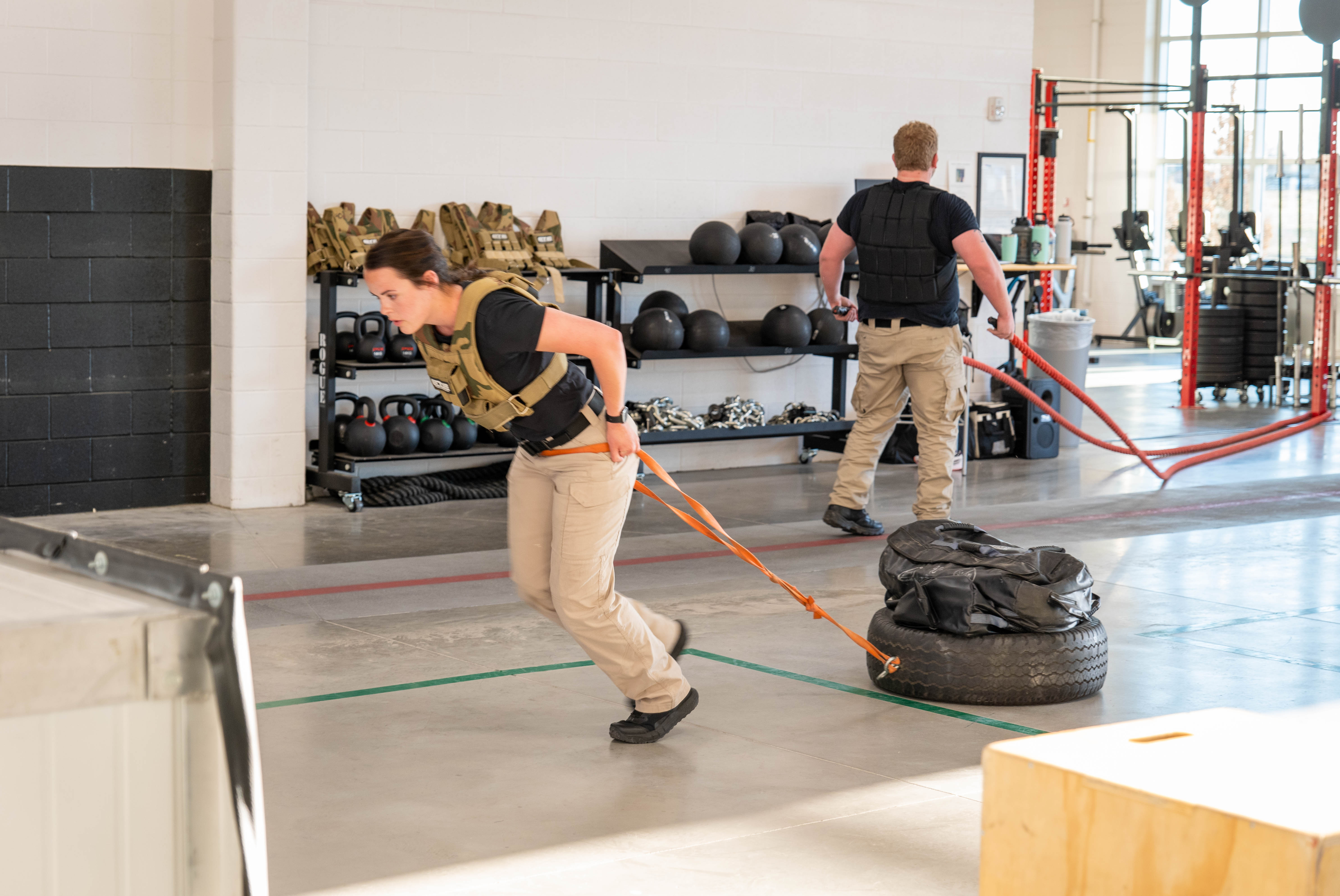 Aims Peace Officer Academy cadets pulling weighted tires during POST physical exam training exercises