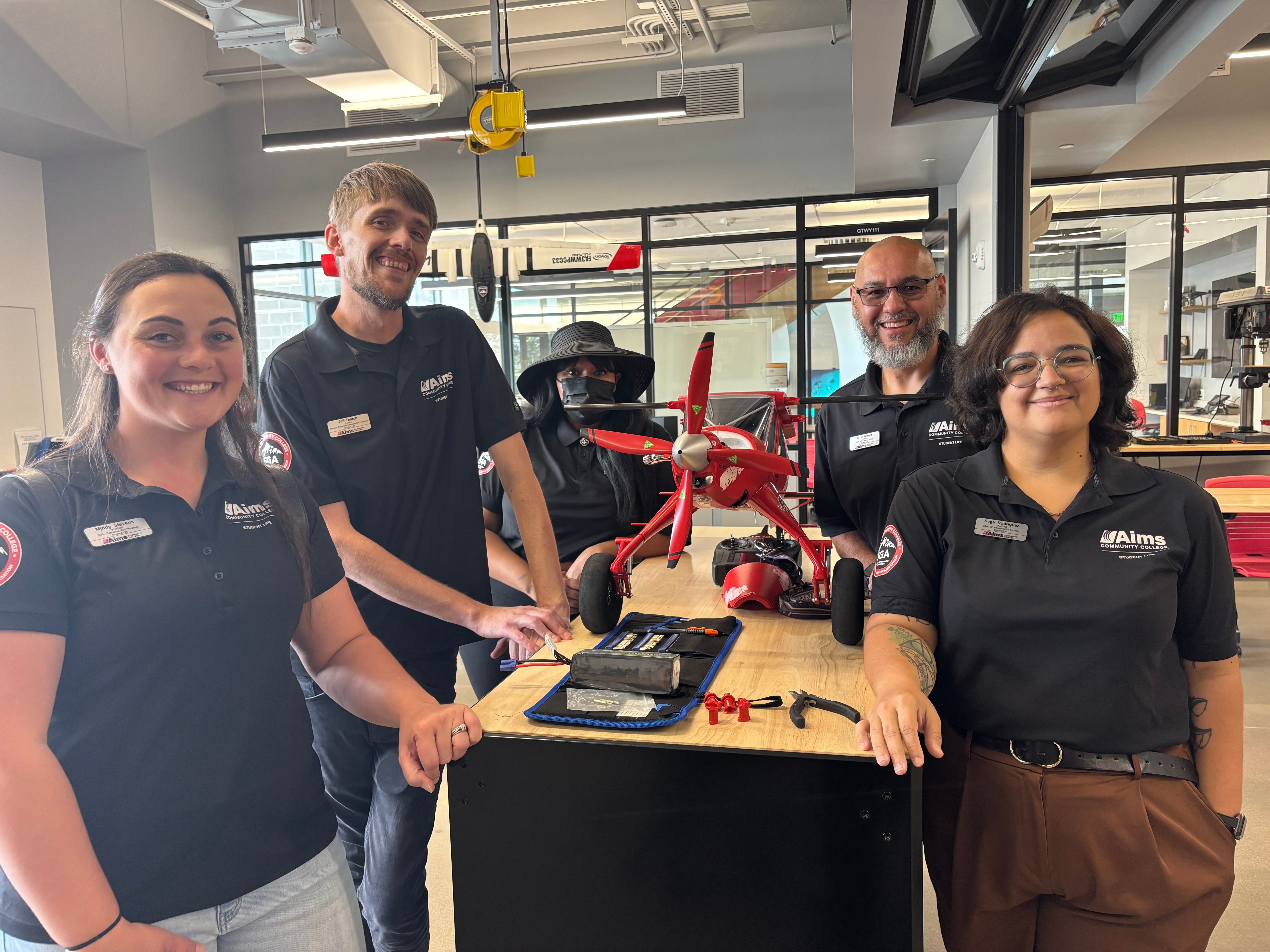SGA posing with an airplane model on the Windsor campus.