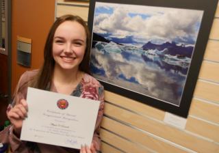 An Aims student shows off an award at the Loveland Art Show