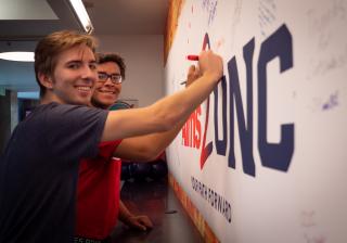 Students Signing Aims2UNC Board