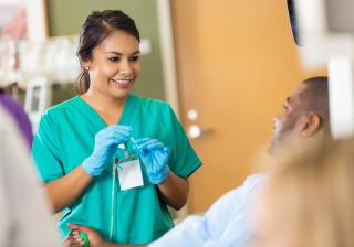 Phlebotomy student preparing to collect blood from a patient