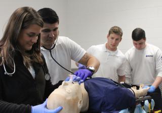 Paramedic students working on a manikin