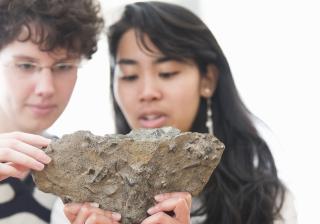 Students in geology lab examining a rock sample