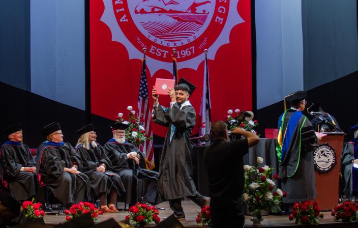 Student on Stage at Commencement