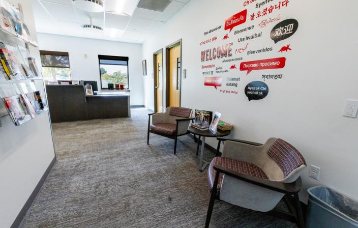 Office space in the Summit Building with two chairs along a wall showing words in multiple languages 