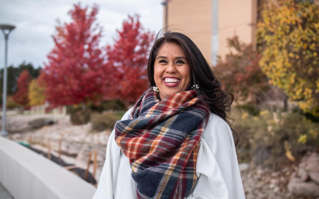 First-generation Aims student Azanet Rodriguez on campus smiling for the camera