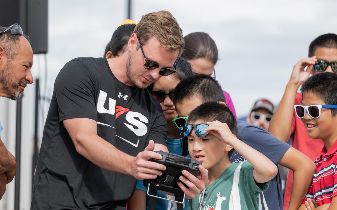 Adult working with child on drone operation