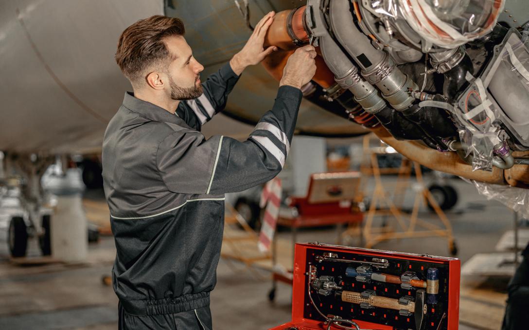 man repairing an airplane