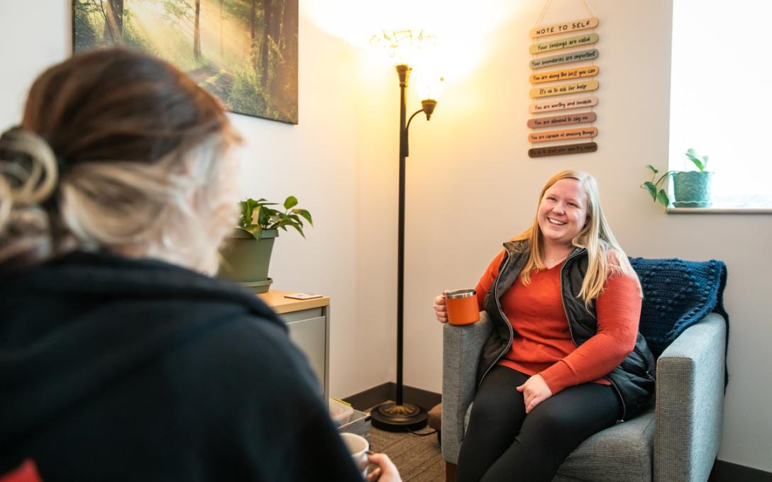 An Aims counselor talks with a student during a counseling session