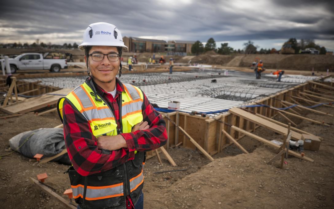 Aims student Amiri Ellington posing at the construction site for the Aims Workforce Innovation Center.