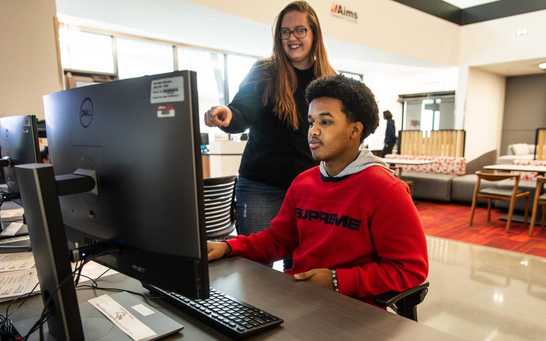 A student applies for Financial Aid on a computer in the Welcome Center.