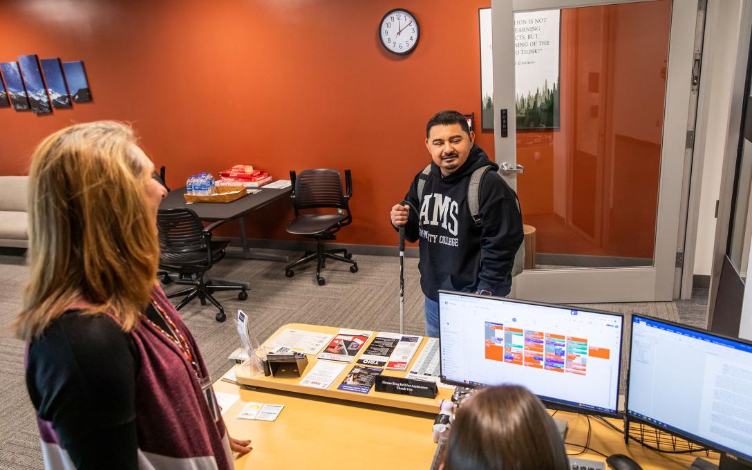 An Aims student meets with staff members of the Disability Access Services department.