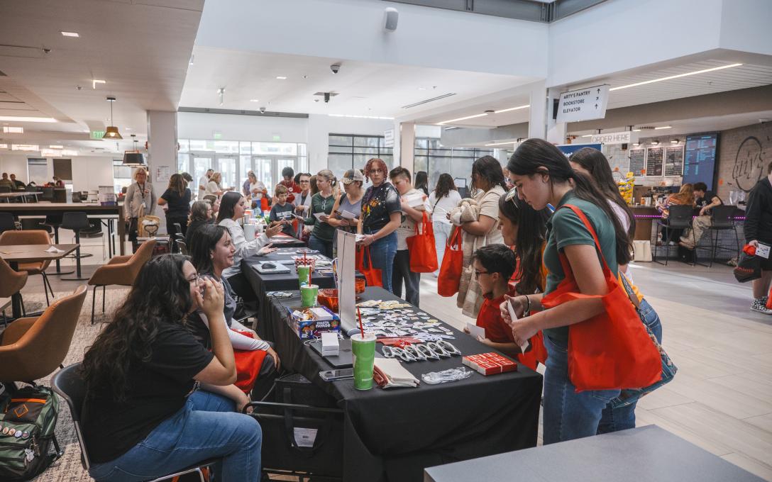 Information Tables and people at Discover Aims Events