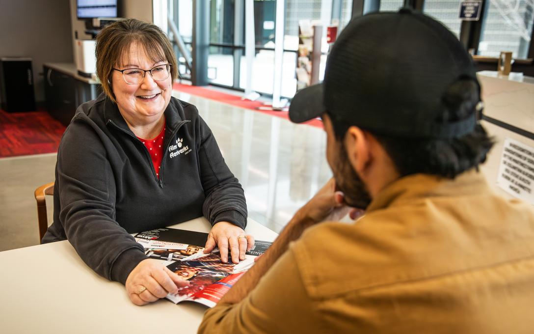 A financial aid advisor meets with a student to discuss how to pay for tuition.