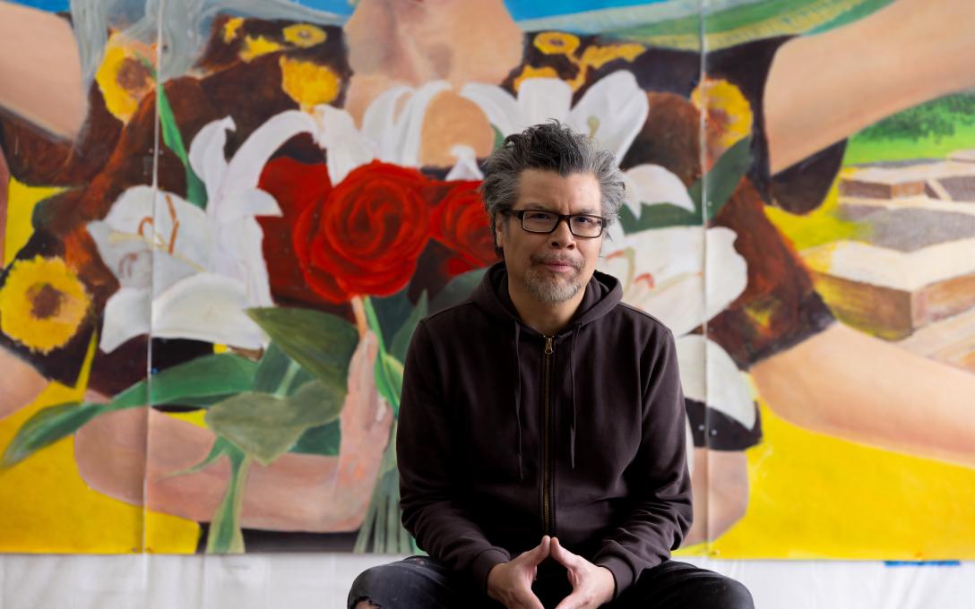 Frank Garza in front of his art