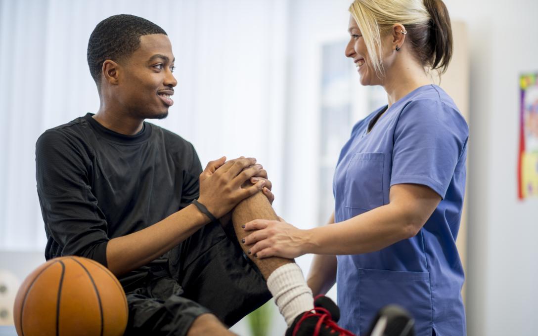 Doctor examining a student's knee