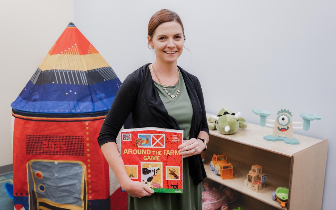 Kaci Trett with kids book in preschool