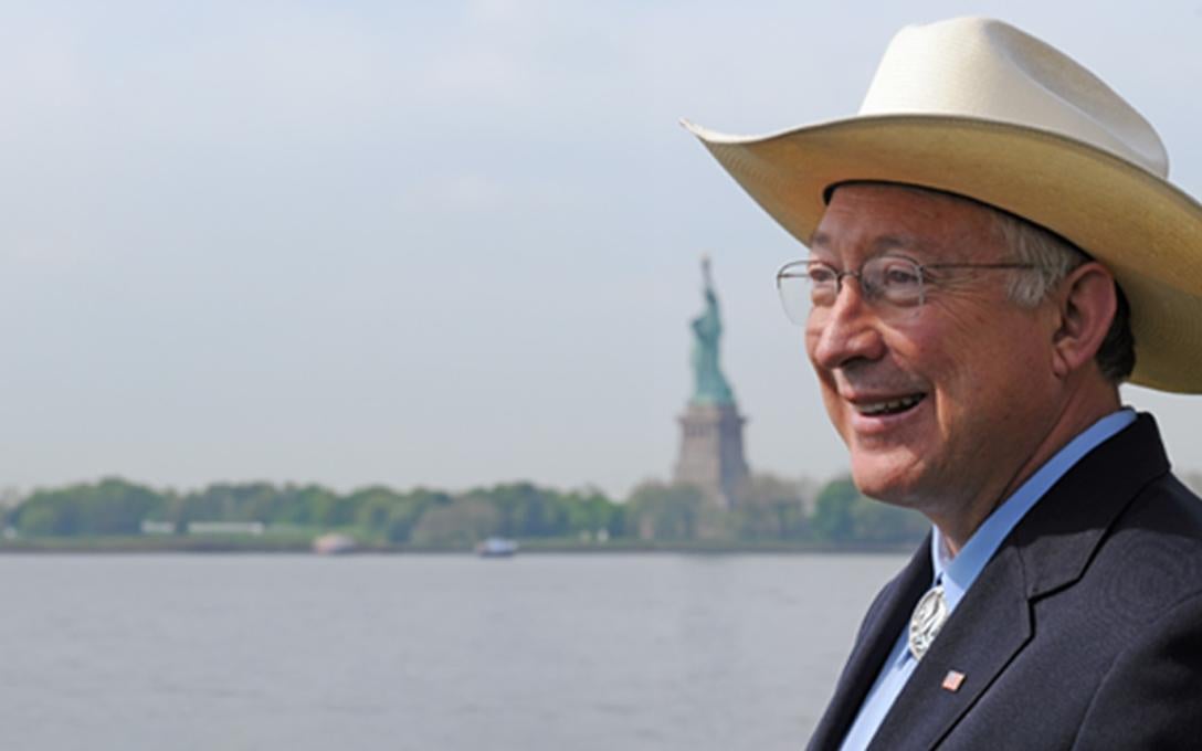Ken Salazar with Statue of Liberty in the background