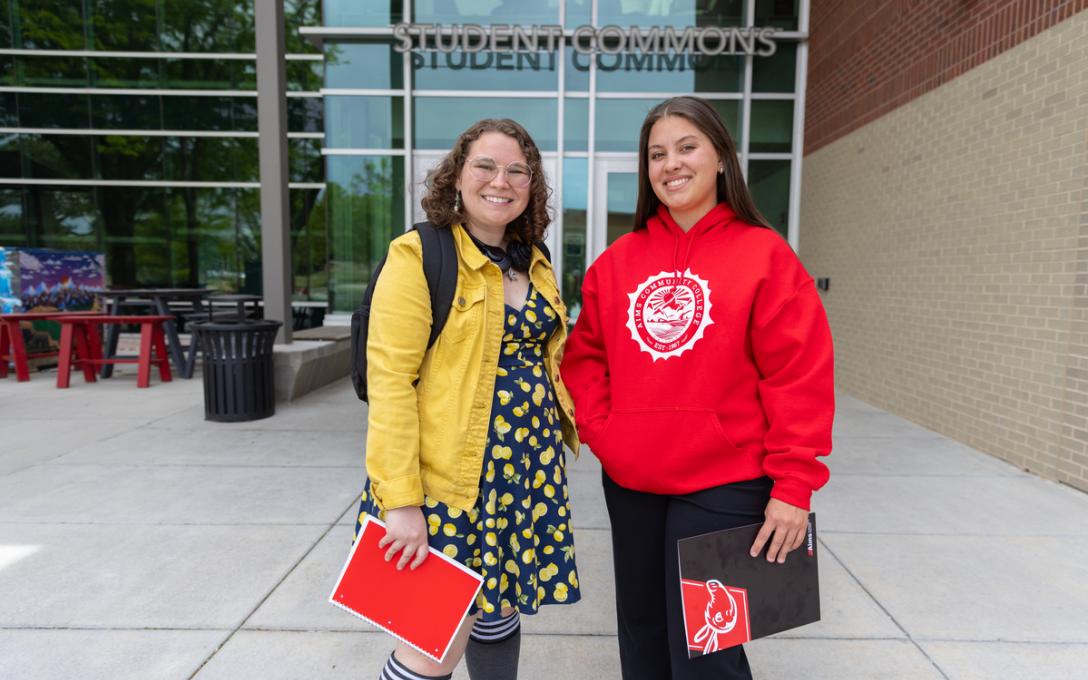 Two students standing outside the Student Commons