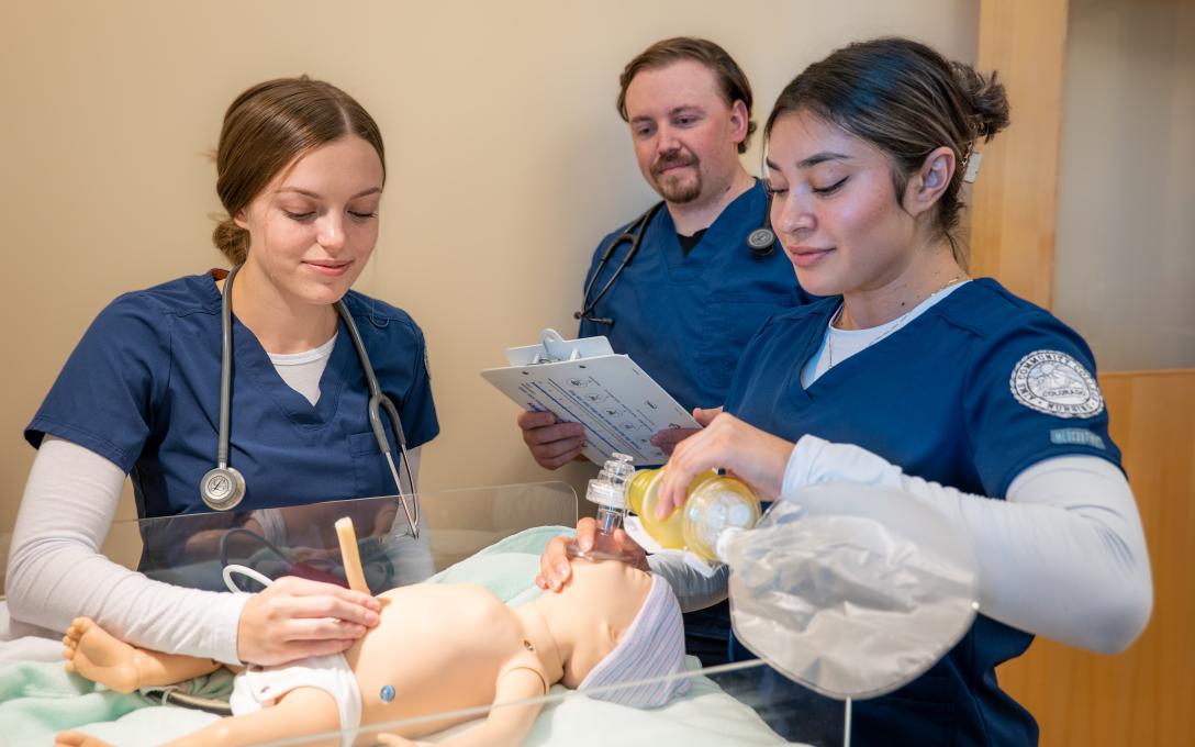 Students with Baby manquin practicing nursing care