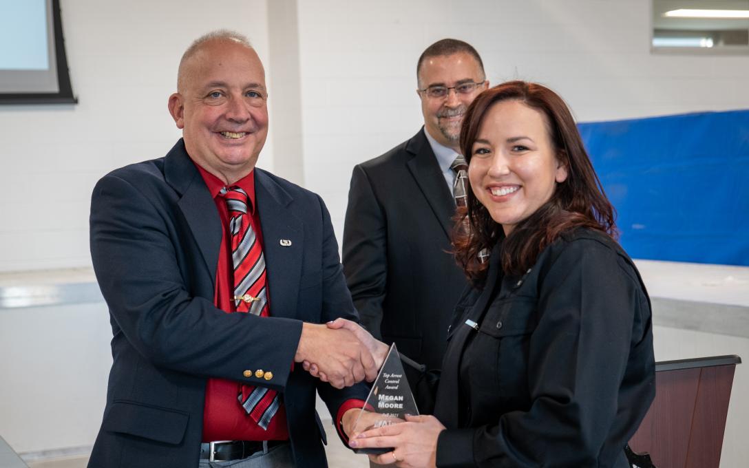 Police Academy alumna Megan Moore receiving the award for Top Arrest Control at the 2021 Aims Police Academy graduation