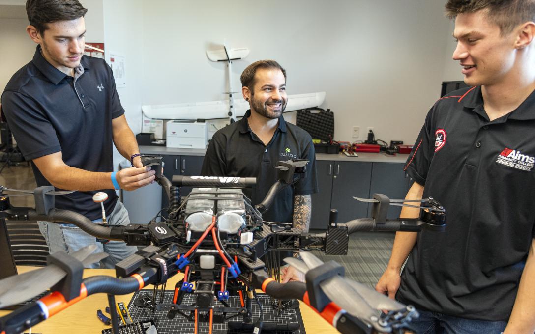 Aims UAS Students working on a drone in a classroom