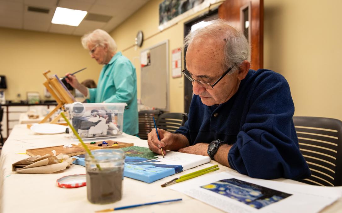 older man and woman in watercolor class