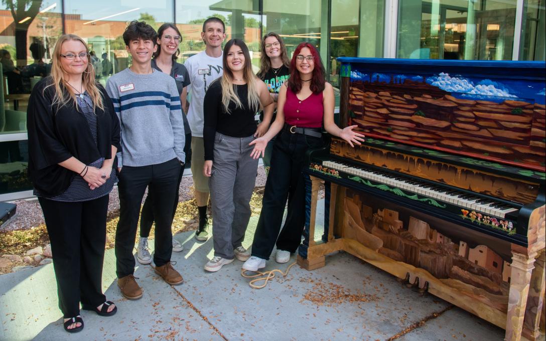 Aims student leaders at with a painted piano on campus