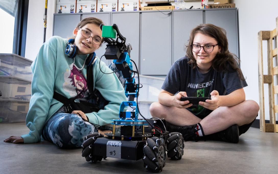 Students on floor with robot