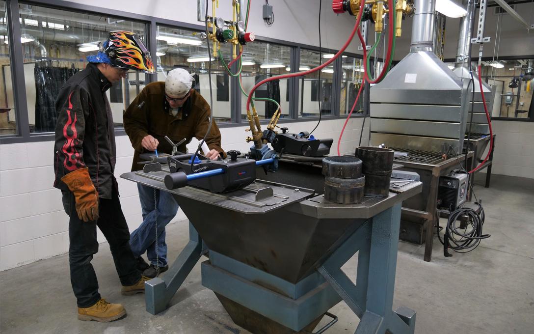 Students using welding equipment in the Welding Technology Wing of the Aims Greeley campus