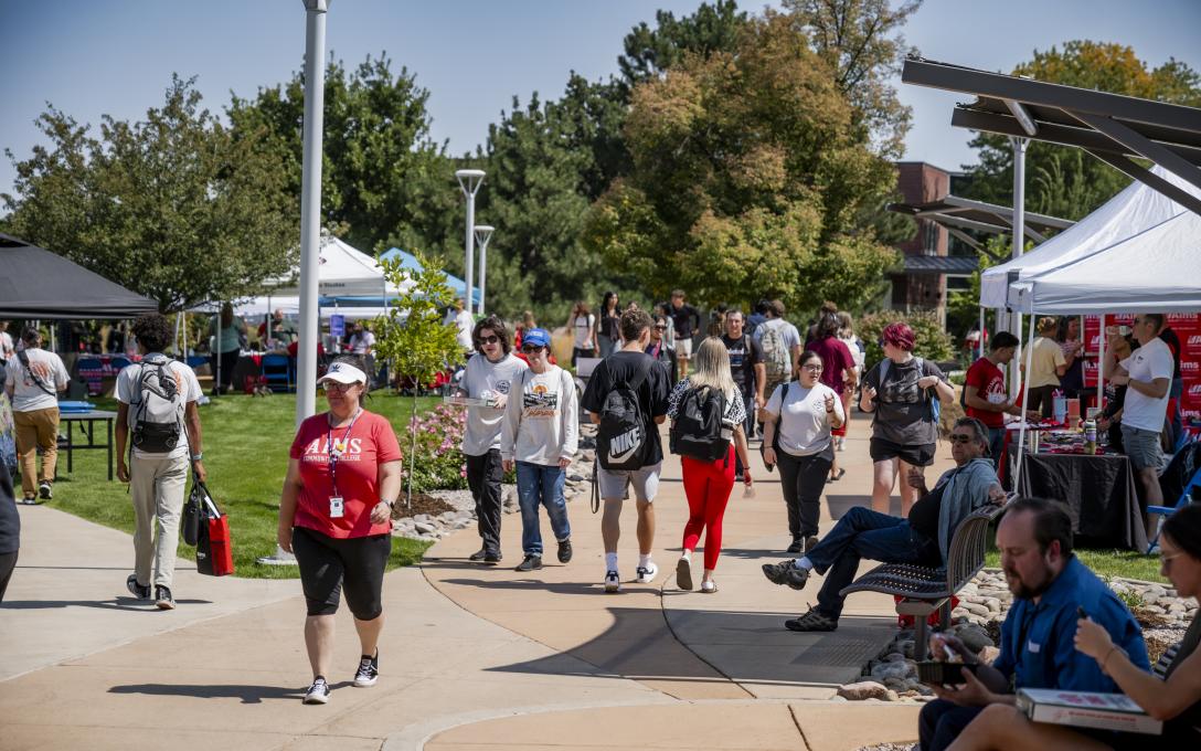 Students walking outdoors on campus walkway
