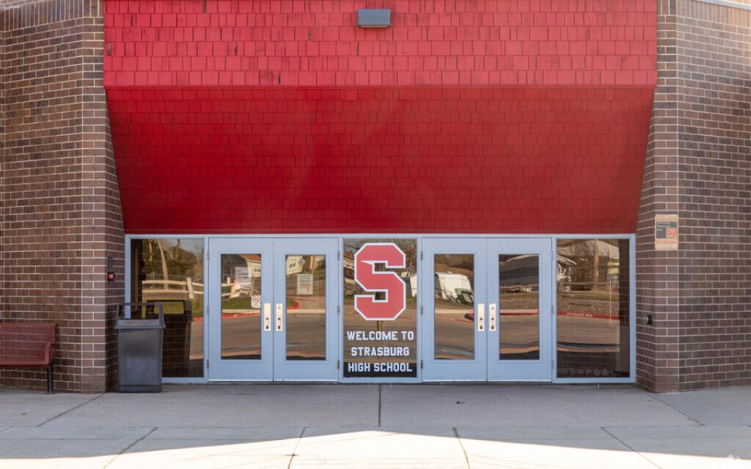 Strasburg high school main entrance two double doors on red wall