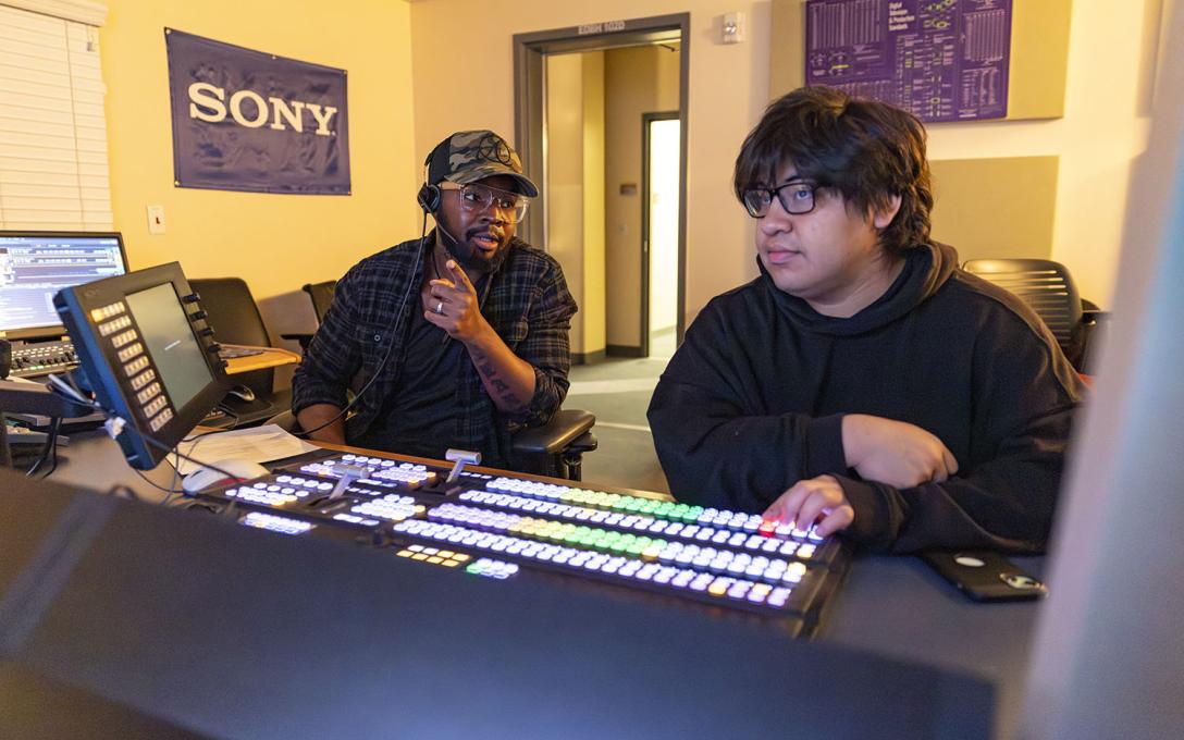 Two students in the Aims Community College Television & Video Production program work together in a control room.