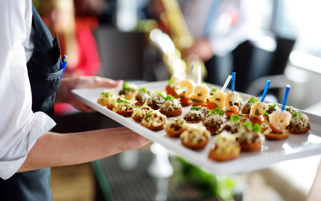 A tray of delicious food held by a server