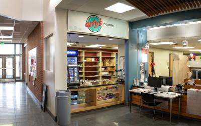 Exterior of Arty's Corner with a counter for people to order food and drinks.