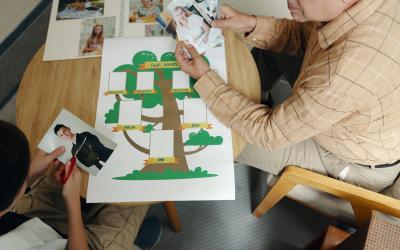 boy and grandfather making family tree at a table