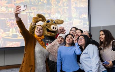Students in Adult Education and English Language Learners programs take a group selfie during a year-end celebration