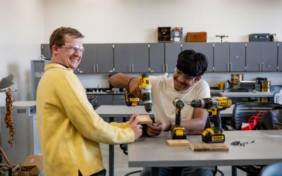 Participants experiment with carpentry equipment in the Experience Aims High School Preview Day 2023