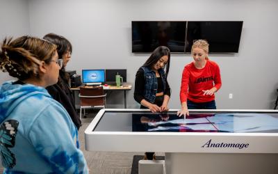 High school students testing an Anatomage table during an Experience Aims event